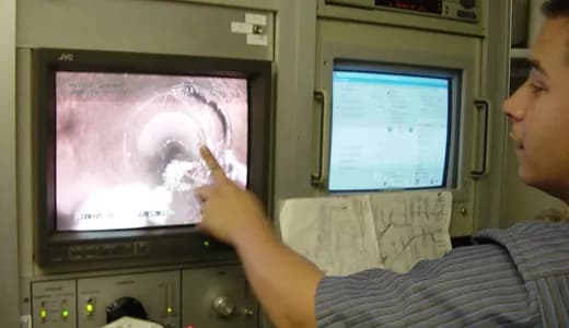 Engineer reviewing CCTV drain survey footage