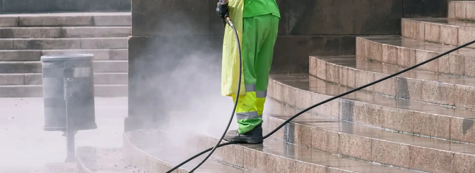 Engineer pressure-washing stone steps