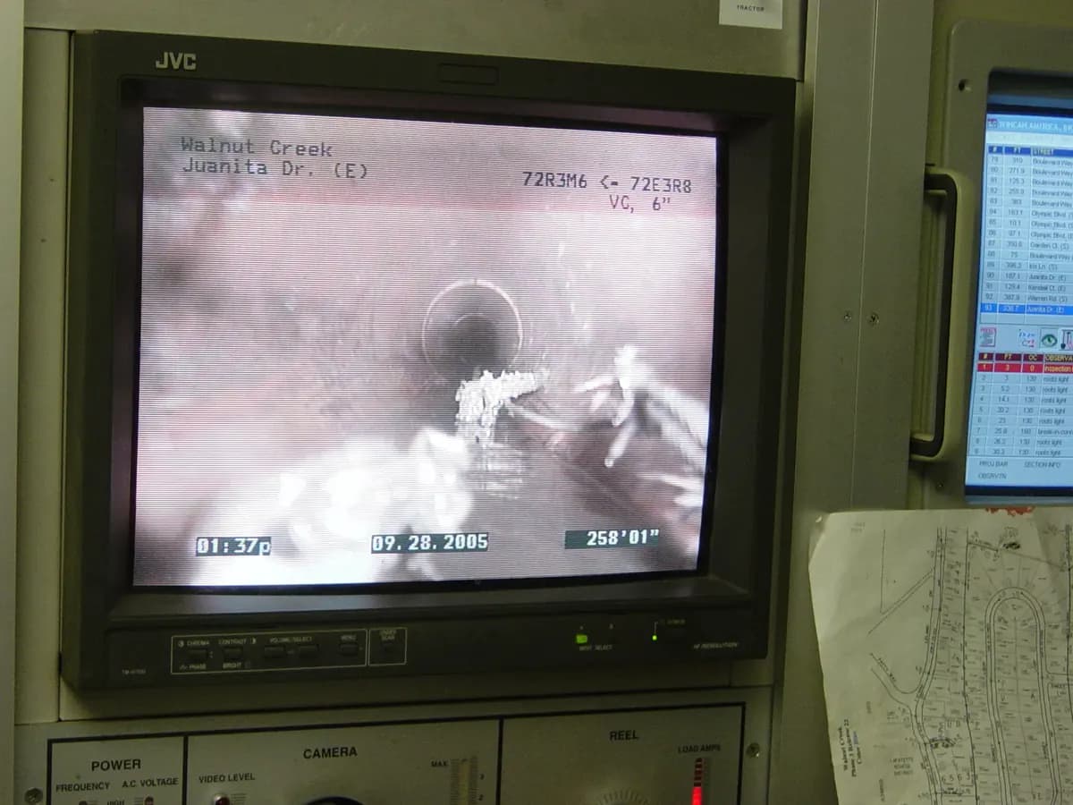 CCTV monitor showing the inside of a drain pipe