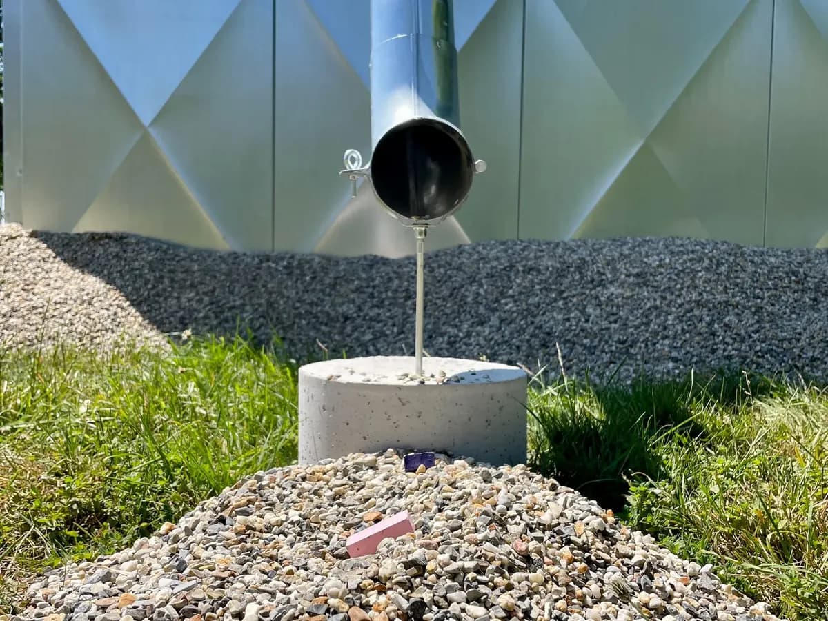 Downpipe discharging onto a gravel soakaway