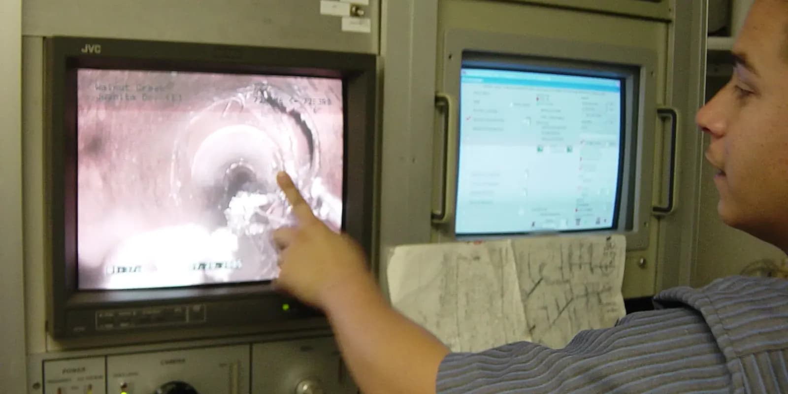 Engineer reviewing CCTV drain camera footage on a monitor