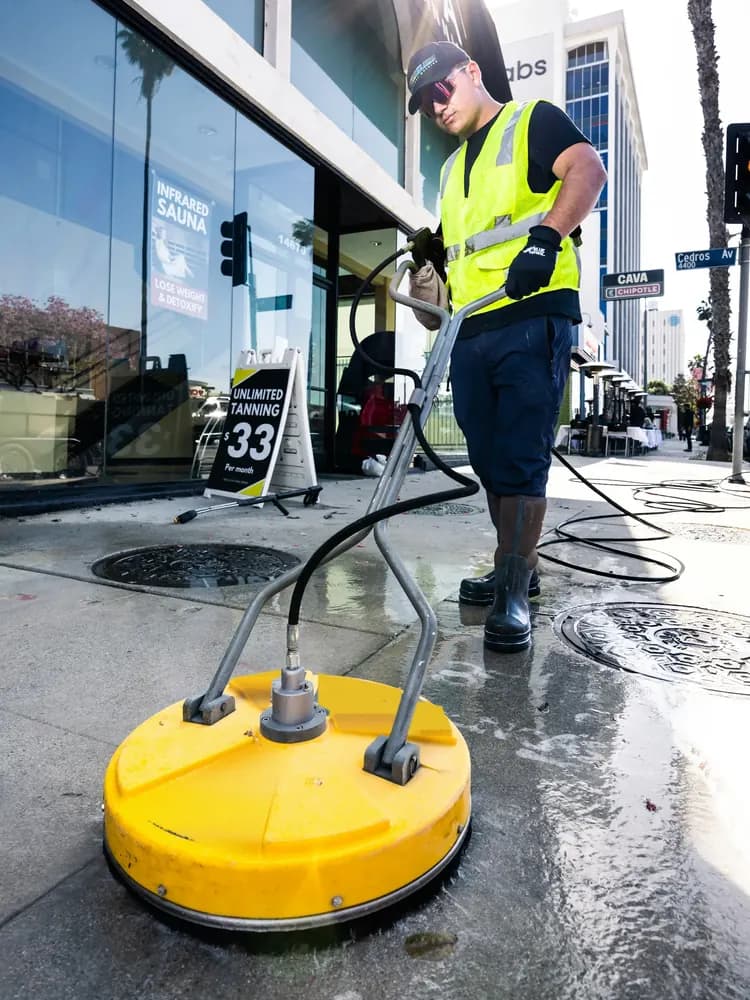 Pressure washer cleaning paving slabs
