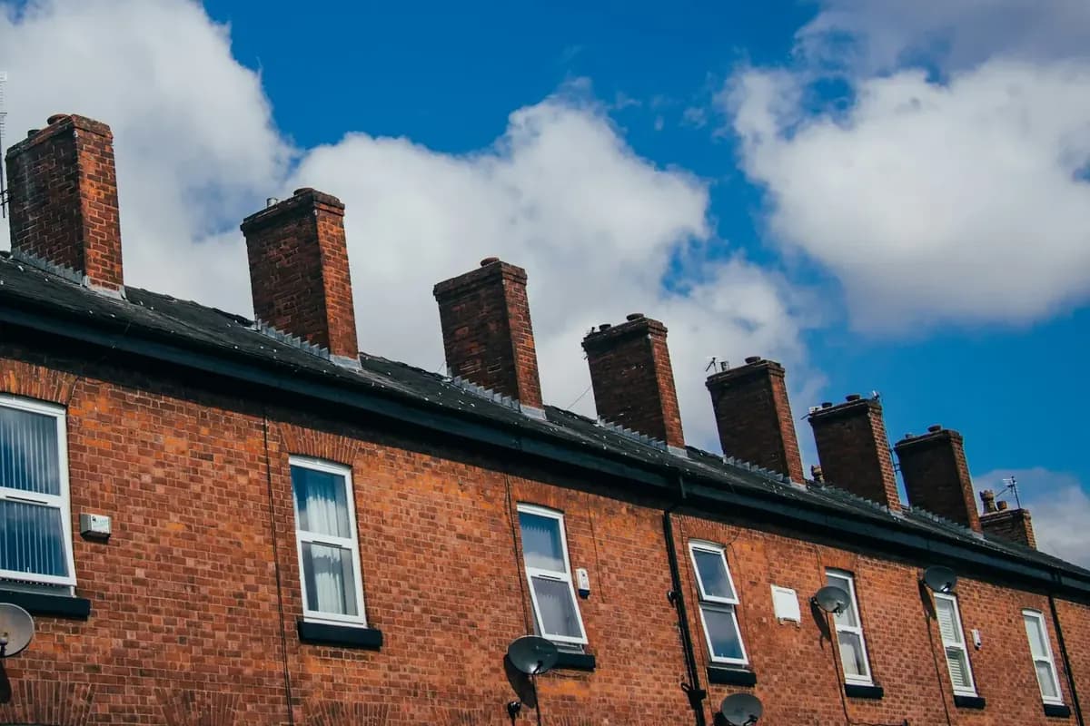 Chimney stacks along a terrace of brick houses